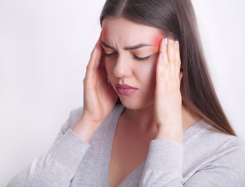 En kvinne som har Hodepine og migrene